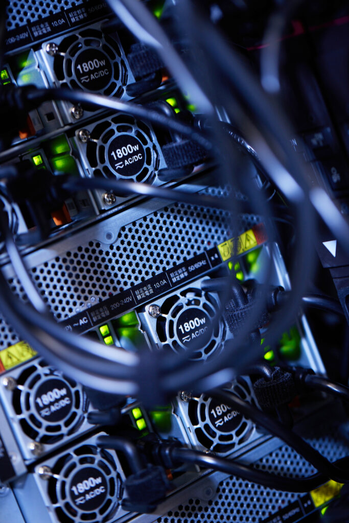 Close-up of server hardware showing cooling fans and network cables in a data centre rack.